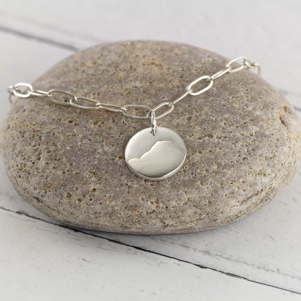 Silver bracelet of Raven Cragg in the Lake District,  on a grey stone